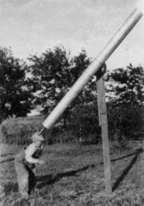 Son Robert peers a telescope